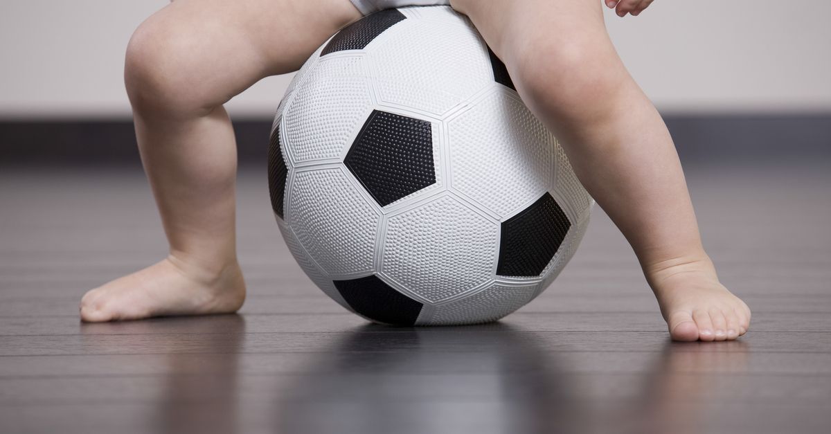 Baby sitzt auf fußball